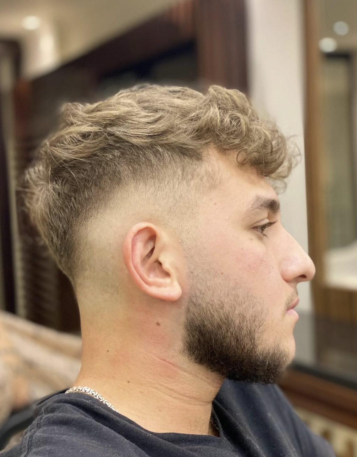 Blonde textured haircut with a clean fade at RK Salon
