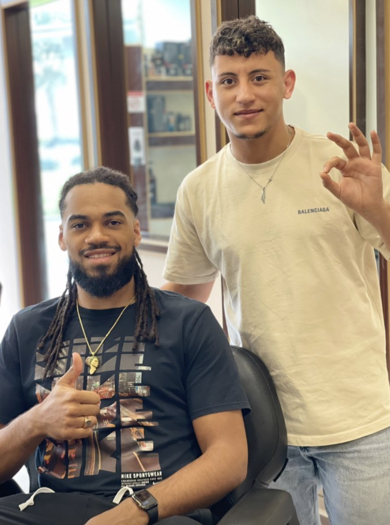 A client and barber at RK Salon after a grooming appointment
